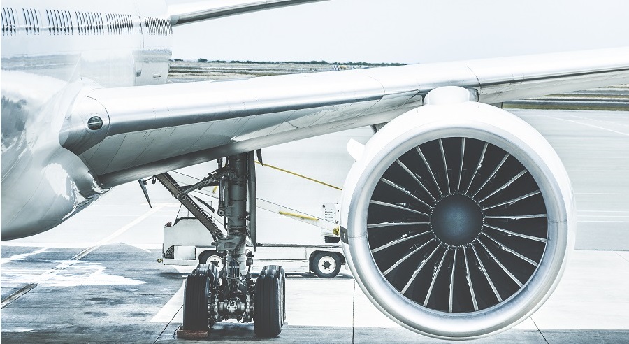 Detail of airplane engine wing at terminal gate before takeoff - Wanderlust travel concept around the world with air plane at international airport - Retro contrast filter with light blue color tones